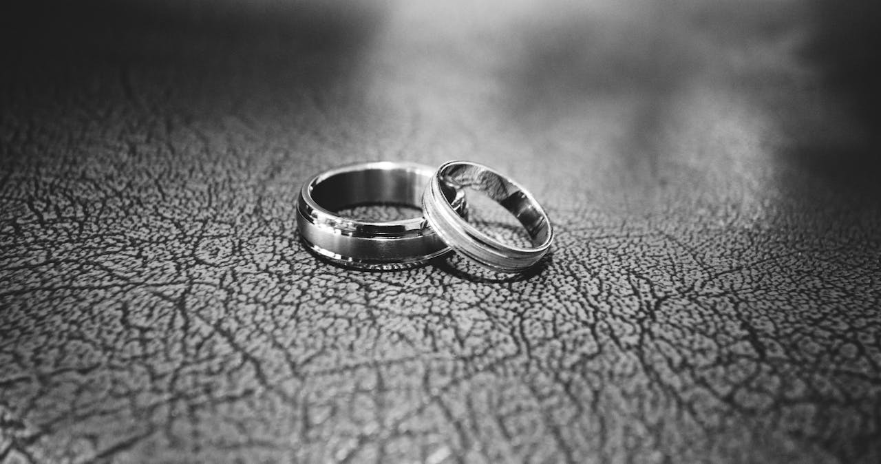 hero-img-02 Elegant black and white close-up of wedding rings symbolizing love and commitment.